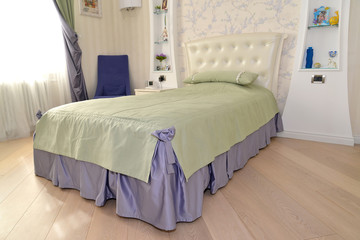 Bed in a children's bedroom. Modern classics with rococo element