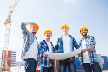 group of builders with tablet pc and blueprint