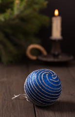 Blue christmas ball with candle and fir branch