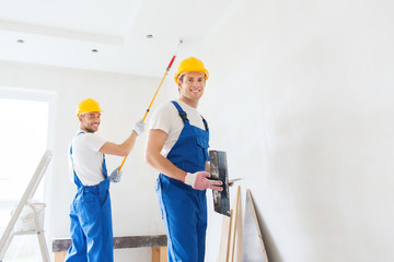 group of builders with tools indoors