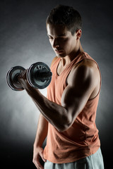 Fototapeta na wymiar young man with dumbbell