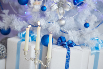 candlestick, three long candles, white Christmas tree with blue