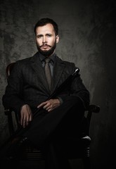 Handsome well-dressed  sitting in leather chair