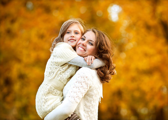 Young mother and her toddler girl have fun