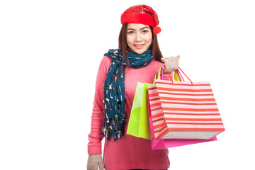 Asian girl with red christmas hat with shopping bags
