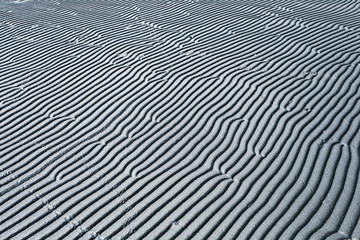 Naklejka na ściany i meble gray texture waves sea sand beach