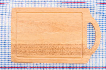 wood cutting board on tablecloth