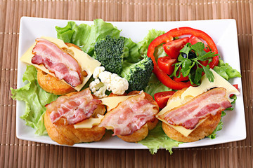 Serving breakfast toast with bacon and herbs