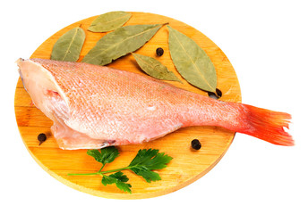 The split sea bass on a round cutting board.