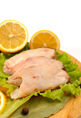 Several pieces of sea bass on a cutting board.