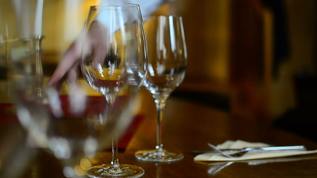 waiter prepairing glases in restaurant