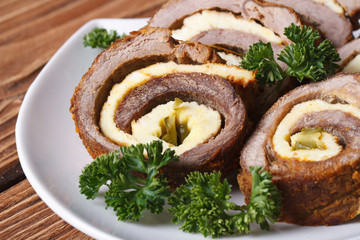 Meat roll with egg and cucumber closeup horizontal.