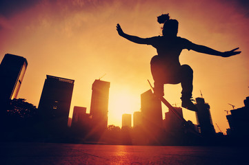 woman skateboarder skateboarding at sunrise city