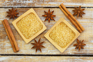 Brown sugar, star anise and cinnamon sticks on rustic wood