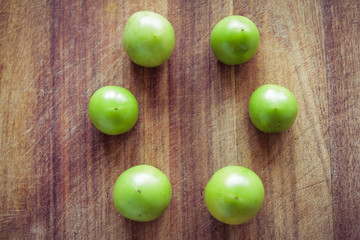 green tomatoes on chopping board