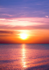 Fototapeta na wymiar Bright Colorful Sunrise On The Sea With Beautiful Clouds
