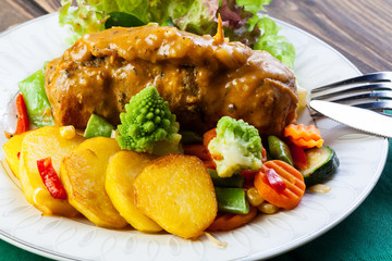 Pork rolls with prepared potatoes and vegetables