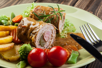 Pork rolls with prepared potatoes and vegetables