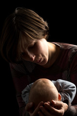 Dark portrait of a loving mother and baby