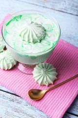 Obraz na płótnie Canvas Mint milk dessert in glass bowl on color wooden background
