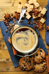 Cup of coffee and chocolate chip cookies on wooden background