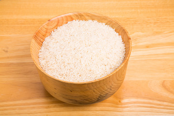 White Rice in Wood Bowl on Wood Table