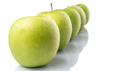 A group of green apples over white background