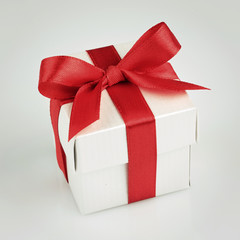 white gift box with red ribbon
