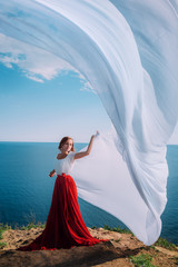 Fototapeta na wymiar Beautiful Girl With White fabric on sea background