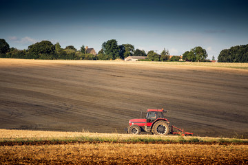 Tractor harrowing a field west of Poitiers in south western Fran - 72818217