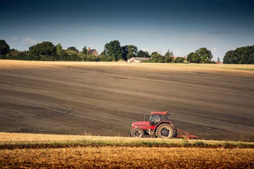 Foto op Canvas Tractor harrowing a field west of Poitiers in south western Fran © jiduha