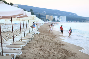 sandy beach sunbeds umbrellas sea