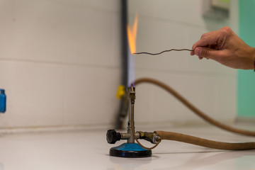 powder test a Bunsen burner showing flame and hose.