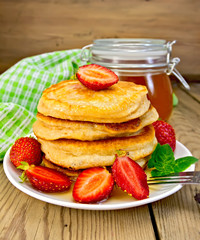Flapjacks with strawberries and honey on board