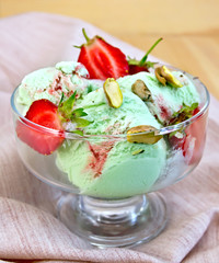 Ice cream strawberry-pistachio on napkin and board