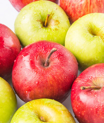 Red and green apple over white background