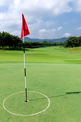 Golf course with flag and beautiful sky 