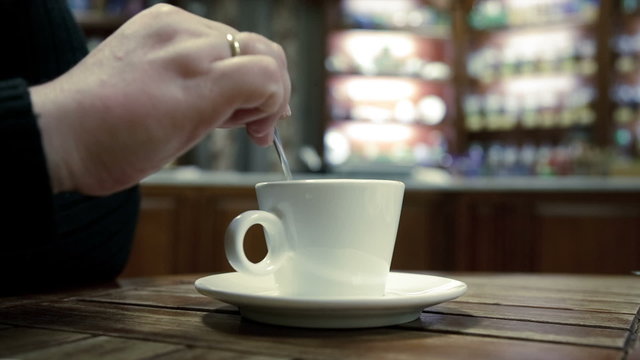 woman s hand mix a sugar in the coffee cup