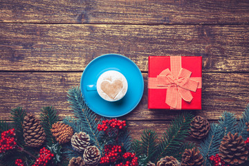 Cup of coffee and gift on a table