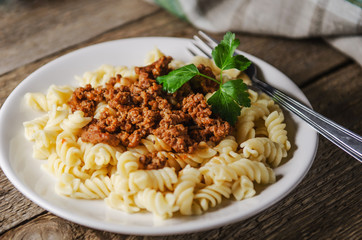 hot pasta with sauce on a white plate