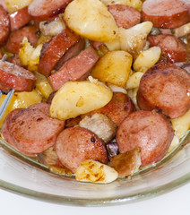 Plate of pieces of sausage, potatoes, garlic and meat