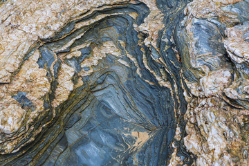 Colored granite and schist rock face