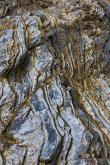 Colored granite and schist rock face
