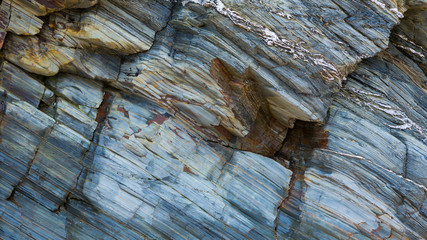 Colored granite and schist rock face