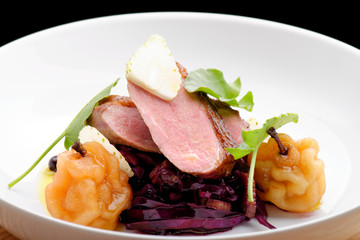 Roast duck, red cabbage and dry fruits in fine dining restaurant