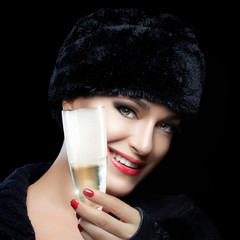 Winter Fashion Young Woman in Fur Hat Toasting with Champagne