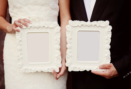 Bride and groom with vintage photo frames