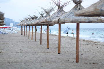 sandy beach sunbeds umbrellas sea