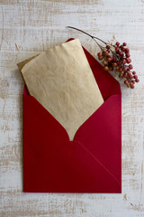 Red envelope, vintage letter, weathered white wood