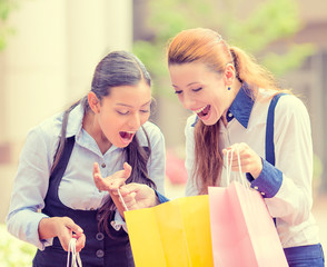 happy, laughing young shopper women outside shopping mall